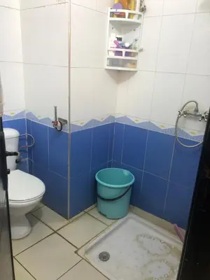 a blue and white bathroom with a toilet at Résidence Nassim al bahr6 in Oulad Akkou