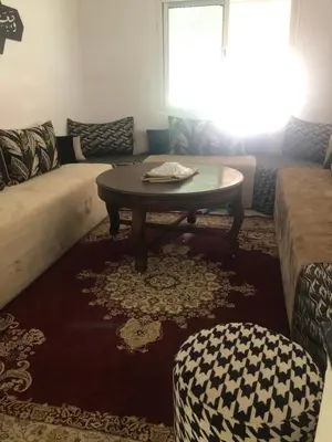 a living room with a coffee table and a couch at Résidence Nassim al bahr6 in Oulad Akkou