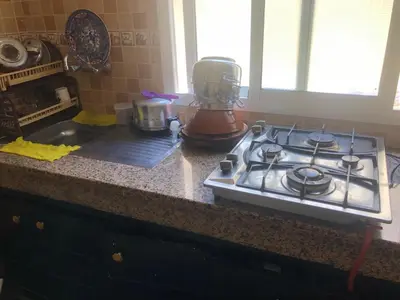 a kitchen counter with a stove and a blender at Résidence Nassim al bahr6 in Oulad Akkou