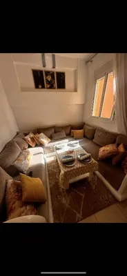 a living room with a couch and a table at Samira in Oulad Akkou