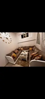 a living room with a couch and a table at Samira in Oulad Akkou