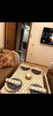 a living room with a table with plates on it at Samira in Oulad Akkou