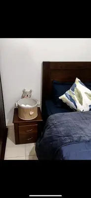 a bedroom with a bed and a nightstand with a bed sidx sidx at Samira in Oulad Akkou
