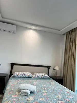 a bedroom with a bed with two towels on it at Villa Belle Rive Estate in Oulad Akkou