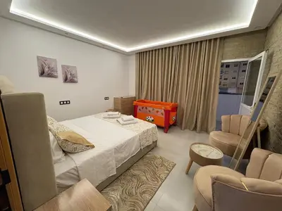a hotel room with a bed and a chair at New Design in Today's Style in Oulad Akkou