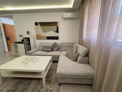 a living room with a couch and a table at New Design in Today's Style in Oulad Akkou