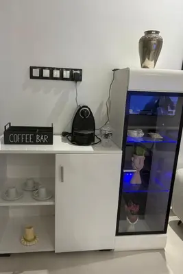 a white coffee bar with a clock on top of it at New Design in Today's Style in Oulad Akkou