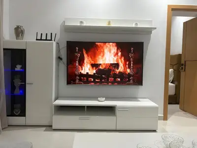 a living room with a fireplace with a tv at New Design in Today's Style in Oulad Akkou