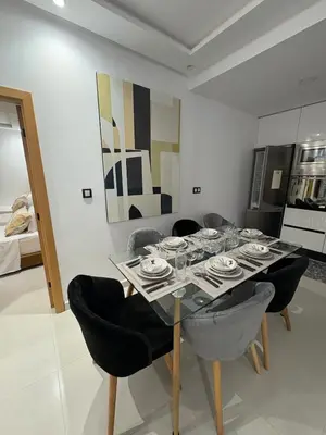 a dining room with a glass table and chairs at New Design in Today's Style in Oulad Akkou