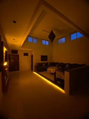 an empty living room with a couch and a light at villa cherif in Azib Oulad Lâdem