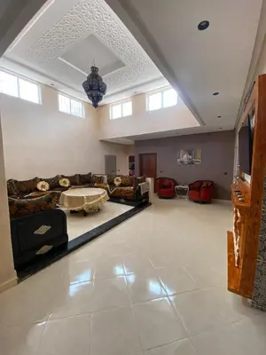 a large living room with couches and a table at villa cherif in Azib Oulad Lâdem