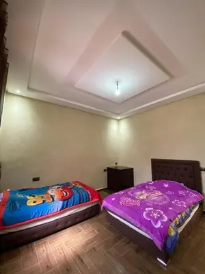two beds sitting next to each other in a room at villa cherif in Azib Oulad Lâdem