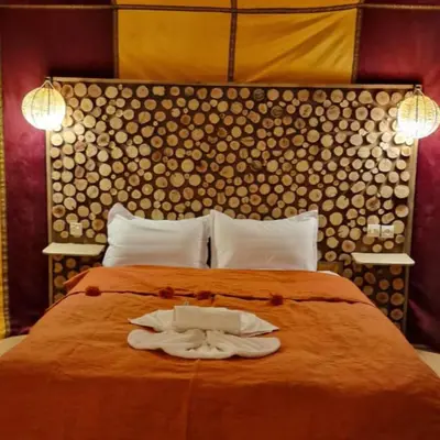 a bedroom with a bed with two towels on it at Luxury camps merzouga in Merzouga