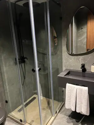 a shower with a glass door in a bathroom at Studio ghandi in Oulad Akkou