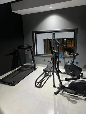 a room with two exercise bikes and a mirror at Studio ghandi in Oulad Akkou