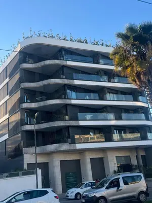a building with cars parked in front of it at Studio ghandi in Oulad Akkou
