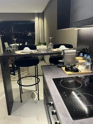 a kitchen with a counter and some bar stools at Studio ghandi in Oulad Akkou