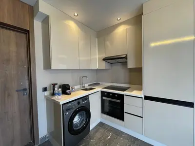 a kitchen with a washer and a dishwasher at Studio Moderne - Bd Anoual in Oulad Akkou