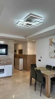 a dining room with a table and chairs at New luxury appartement in Oulad Akkou