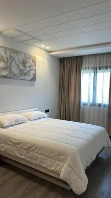a bedroom with a large bed and a window at New luxury appartement in Oulad Akkou