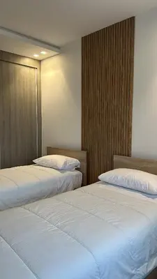 two beds sitting next to each other in a room at New luxury appartement in Oulad Akkou