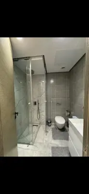 a bathroom with a shower and a toilet and a sink at New luxury appartement in Oulad Akkou