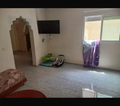 a living room with a flat screen tv on the wall at اصيلة in Oulad Akkou