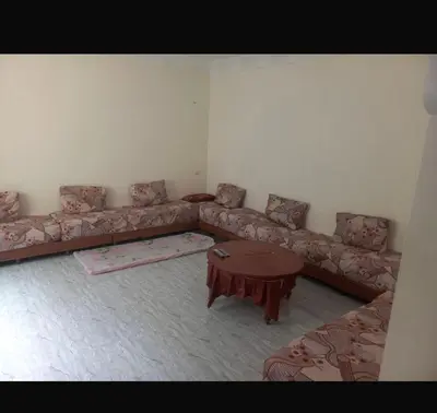 a living room with a couch and a table at اصيلة in Oulad Akkou