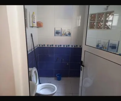 a bathroom with a toilet and a blue wall at اصيلة in Oulad Akkou