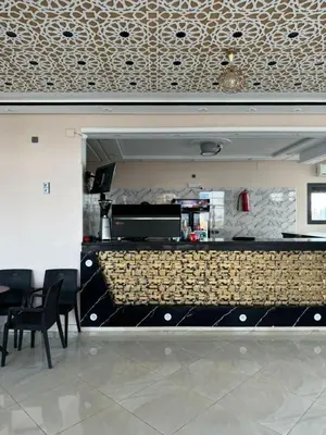 a bar in a restaurant with chairs and a counter at Cafe Restaurant Moove Oil in Rissani