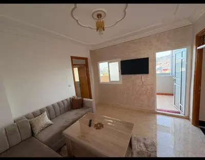 a living room with a couch and a table at Appartement vue mer quartier port 4 in Oulad Akkou