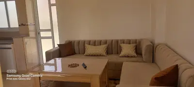 a living room with a couch and a coffee table at Appartement vue mer quartier port 4 in Oulad Akkou