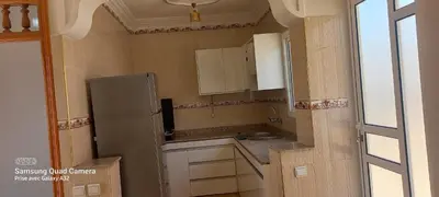 a small kitchen with a sink and a refrigerator at Appartement vue mer quartier port 4 in Oulad Akkou