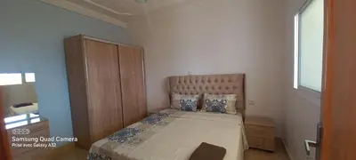a small bedroom with a bed and a window at Appartement vue mer quartier port 4 in Oulad Akkou