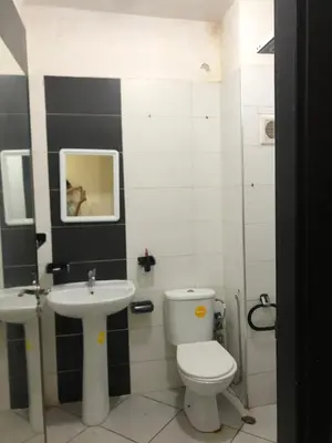a bathroom with a toilet and a sink at مارتيل in Oulad Akkou