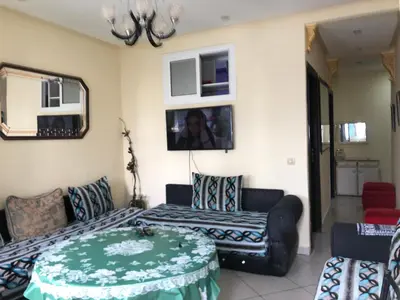 a living room with a couch and a table at مارتيل in Oulad Akkou