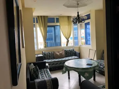 a living room with a couch and a table at مارتيل in Oulad Akkou