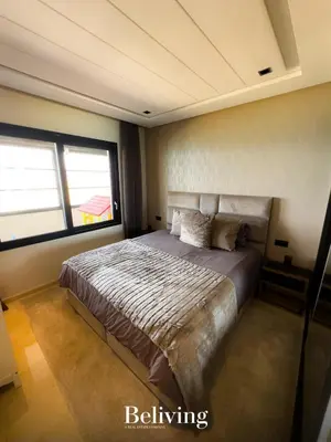 a bedroom with a bed and a large window at Luxurious penthouse with sea view in Oulad Akkou