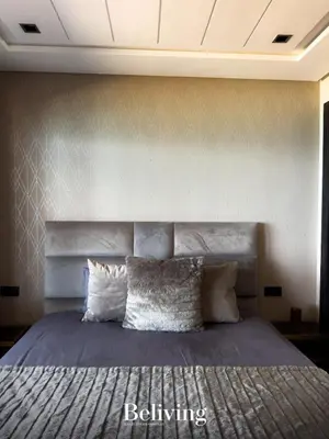 a bedroom with a large bed with pillows at Luxurious penthouse with sea view in Oulad Akkou