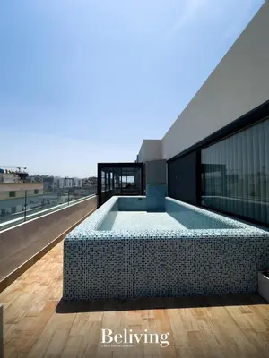 a swimming pool on the roof of a building at Luxurious penthouse with sea view in Oulad Akkou