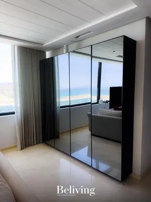 a living room with a large glass wall at Luxurious penthouse with sea view in Oulad Akkou