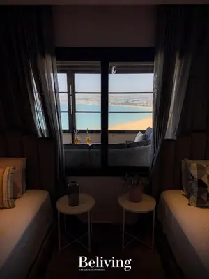 a bedroom with a window with a view of the beach at Luxurious penthouse with sea view in Oulad Akkou