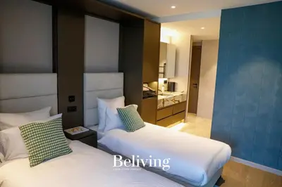 a hotel room with two beds and a bathroom at Luxury, private pool and sea view in Oulad Akkou
