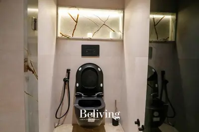 a bathroom with a black toilet in a stall at Luxury, private pool and sea view in Oulad Akkou