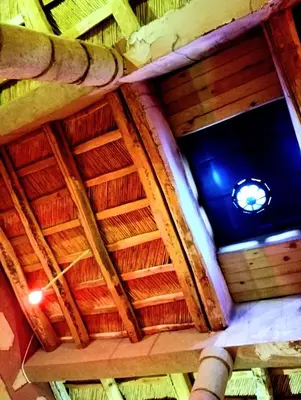 an overhead view of a wooden ceiling of a building at Gite le Calme café Restaurant Pizzeria in Bou Tharar