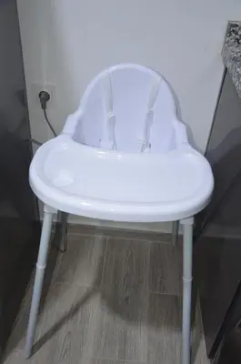 a white chair in the corner of a room at Cozy Apartment close to amenities in Fès