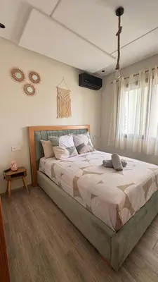 a bedroom with a large bed in a room at Cozy Apartment close to amenities in Fès