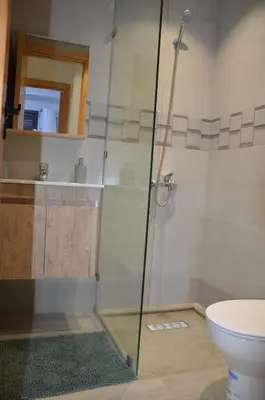a bathroom with a shower and a toilet at Cozy Apartment close to amenities in Fès