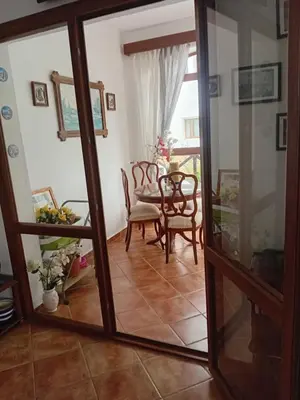 a room with a table and chairs and a mirror at Chic appartement costa cabo in Oulad Akkou