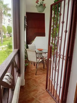 an open door to a patio with a table and chair at Chic appartement costa cabo in Oulad Akkou